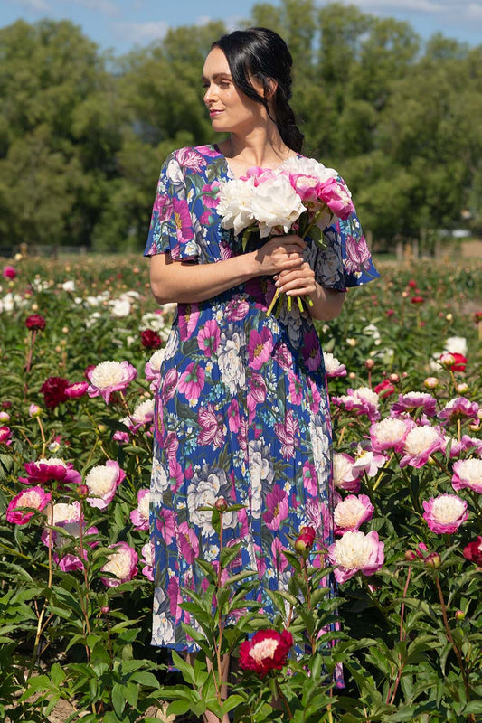 Model wearing Talor vivian dress in navy maria with pleats by annah stretton