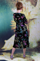 Back of model wearing the Annah Stretton Winter Rose Dress in Black Burnout