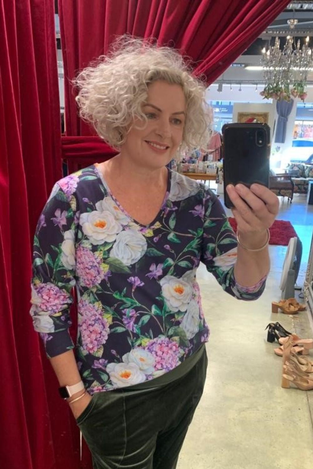 Model wearing long sleeve purple floral top