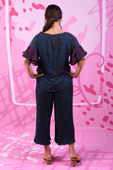 Model wearing navy pleated wide leg pants