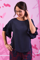 Close-up of model wearing the Dayna Top in plain navy