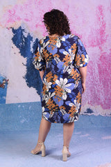 model wearing delta puff sleeve tropical print navy dress
