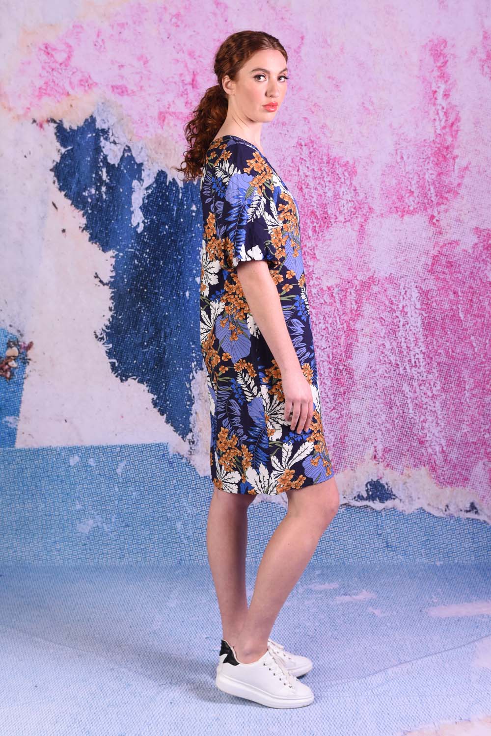 model wearing delta puff sleeve tropical print navy dress