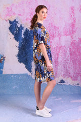 model wearing delta puff sleeve tropical print navy dress