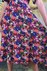 Close-up of multi-coloured floral echinacea fabric of the Down the Line dress