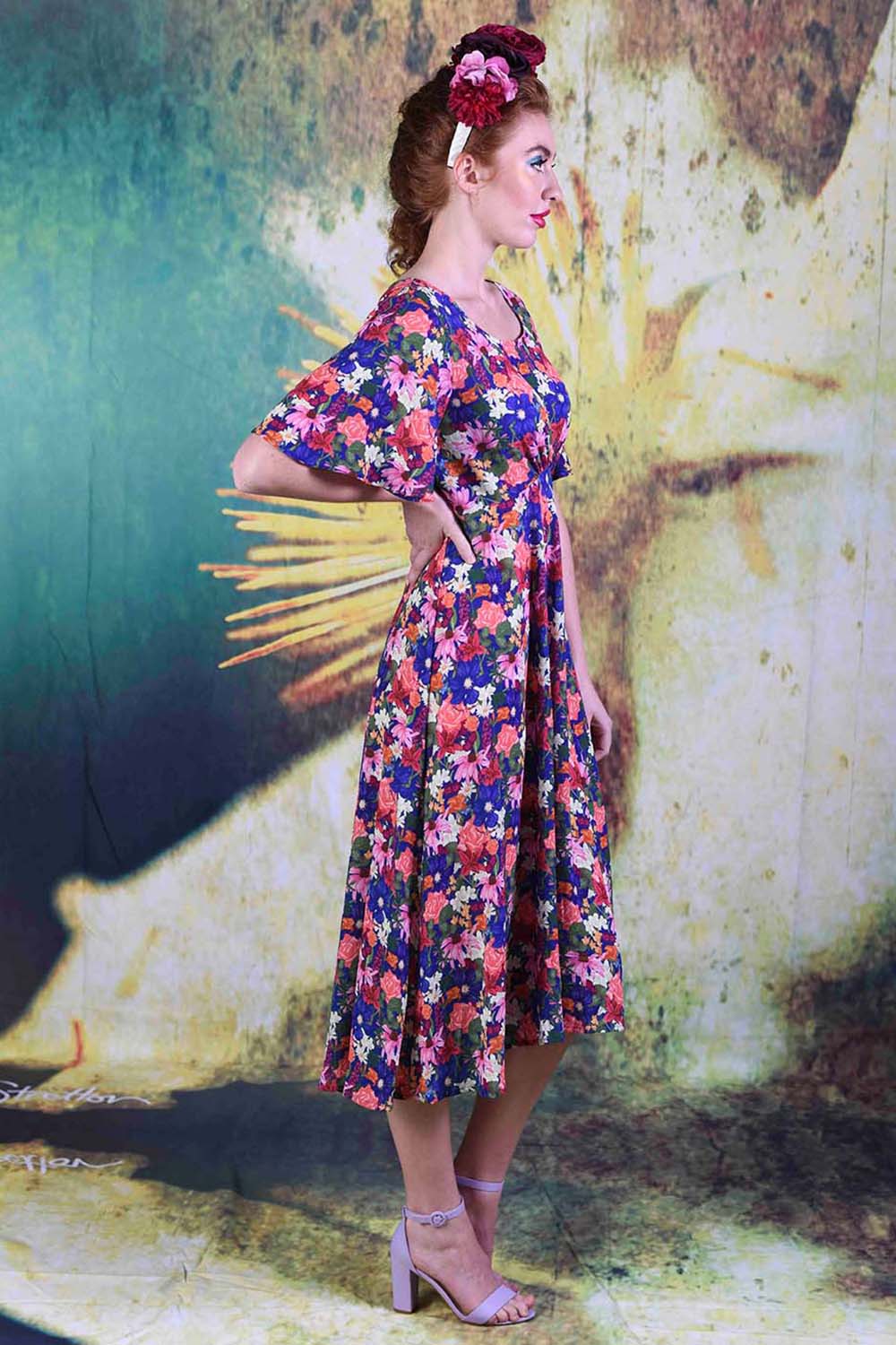 Side of model wearing the Annah Stretton Down the Line dress in echinacea