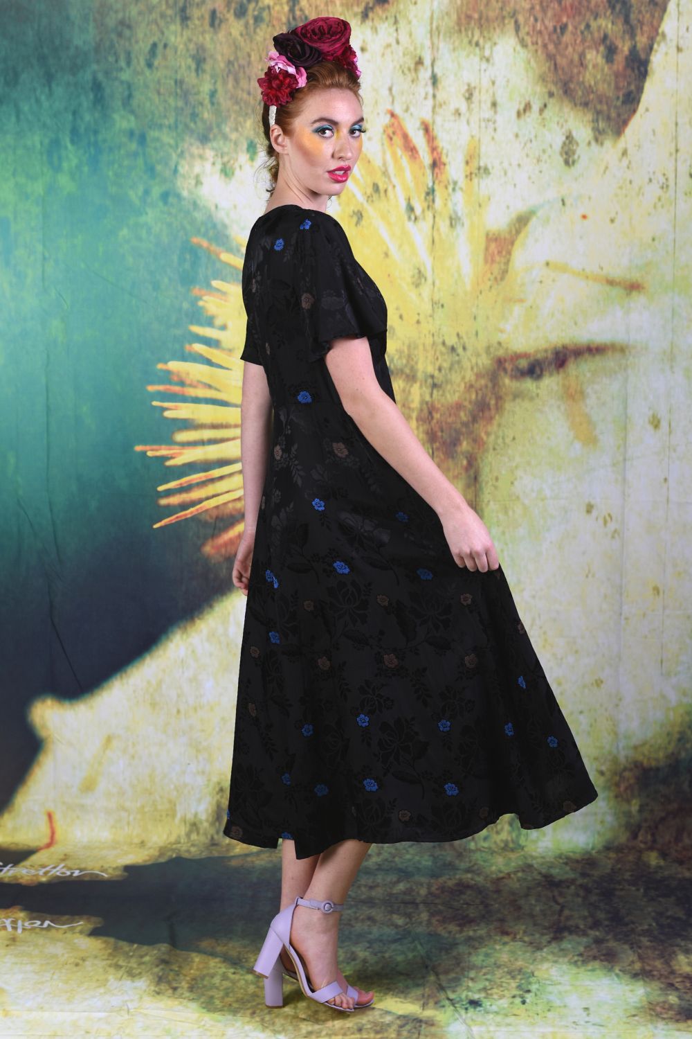 Side of model wearing the Annah Stretton Fabia Dress in black