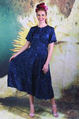 Model wearing the Annah Stretton Fabia Dress in Ocean Blue