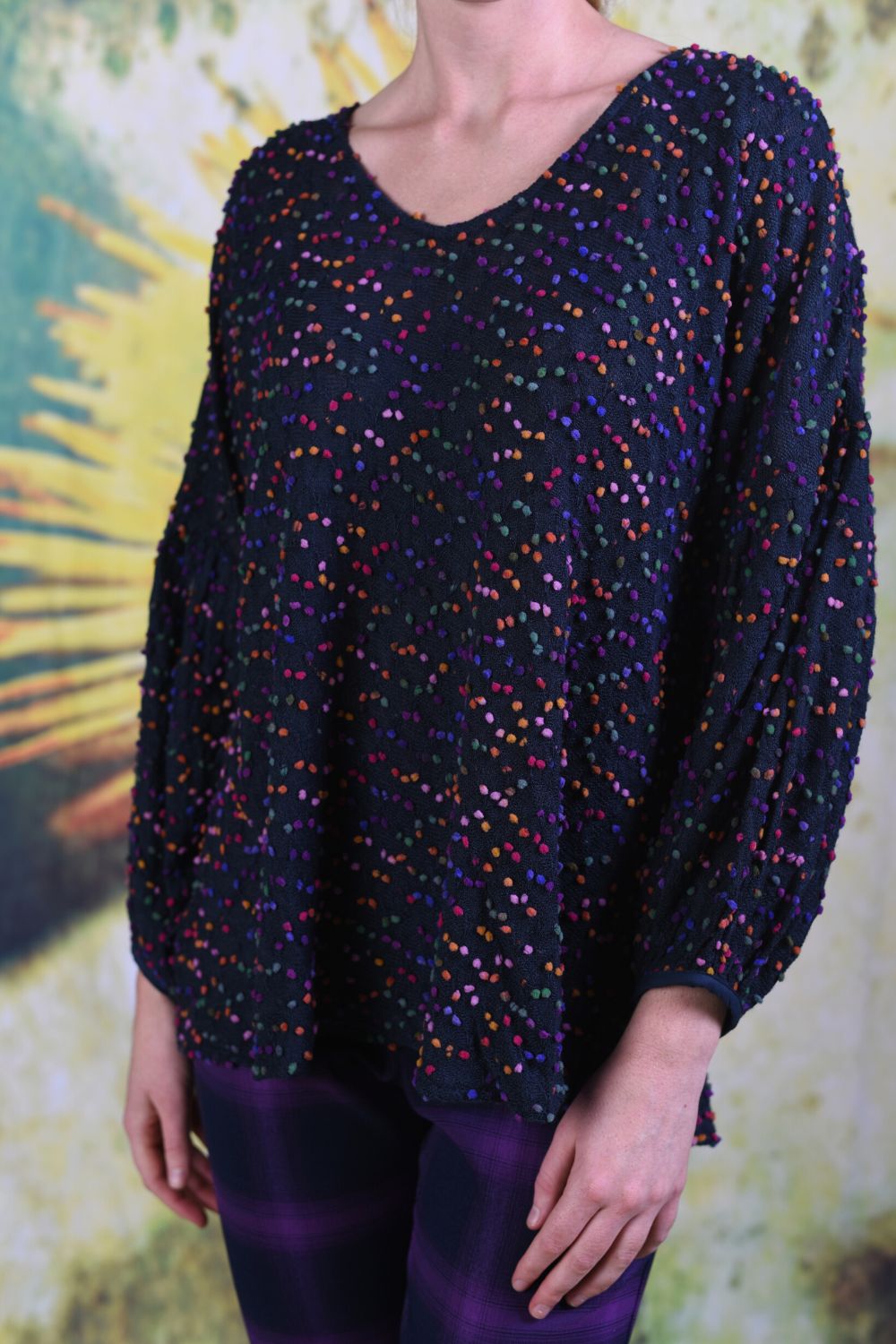 Close-up of Annah Stretton Lola Top featuring small multi-coloured pompoms