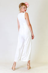 lucy lana jumpsuit in white, back view with flower hair clip
