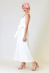 lucy lana jumpsuit in white, side view with flower hair clip