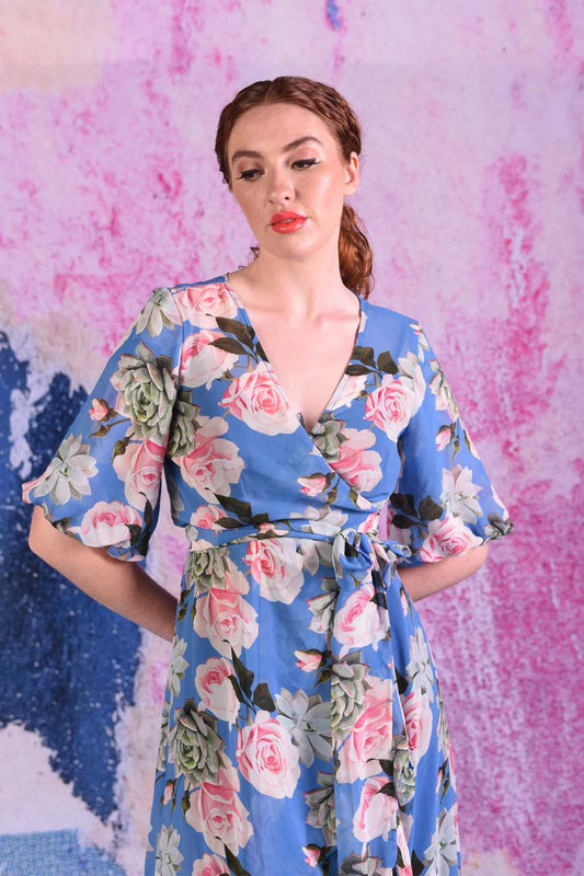 Model wearing marshy mist blue rose dress.