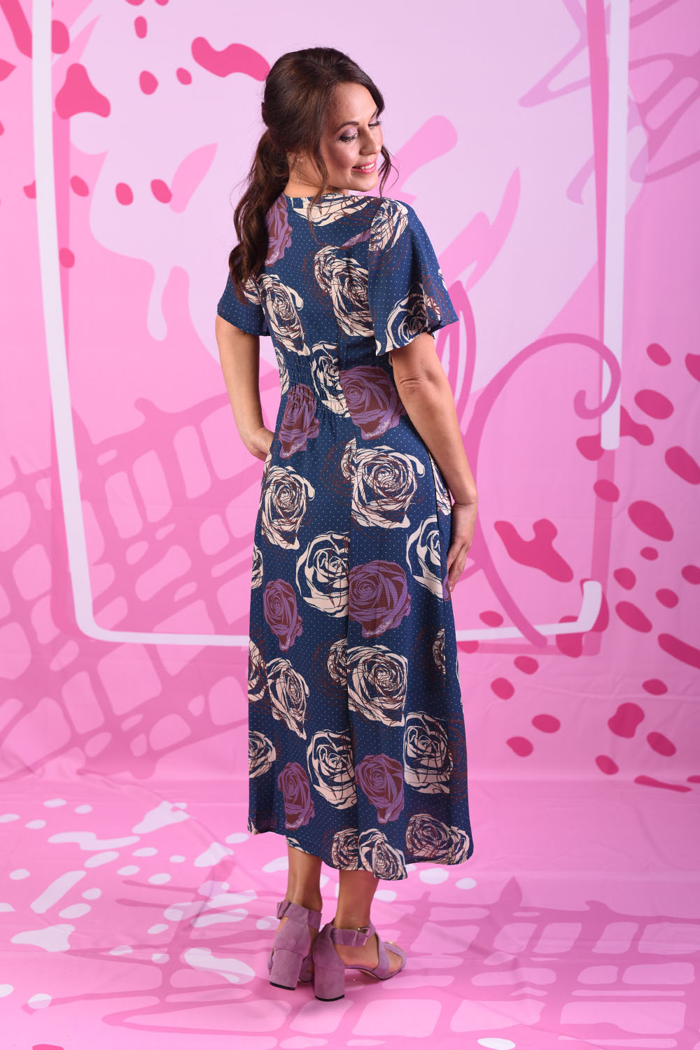 Model wearing navy floral dress by Annah Stretton
