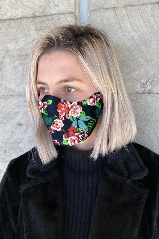 woman wearing cotton navy floral face mask